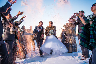 Bride and Groom Running Through The Snow