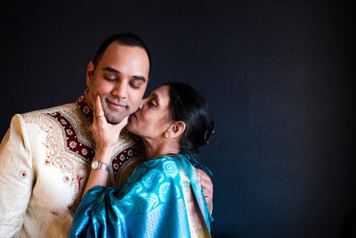 Mother Kissing Groom Before The Wedding