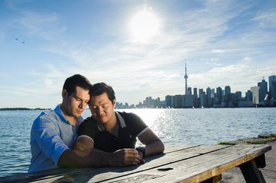 Couple at a picnic table, downtown Toronto background