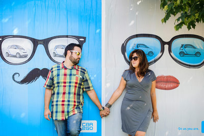 Couple Holding Hands Beside a Sunglasses Ad