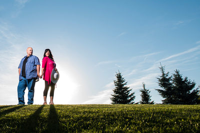 Couple holding hands in grassy Richmon Green