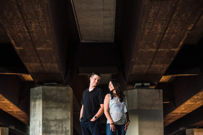 Toronto couple stands underneath Gardiner Expressway