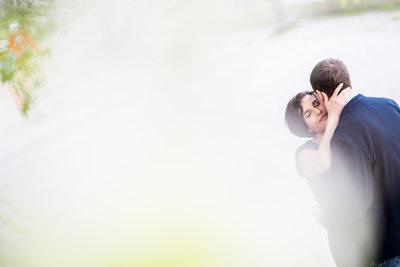 A woman embraces fiance on edge of Lake Ontario