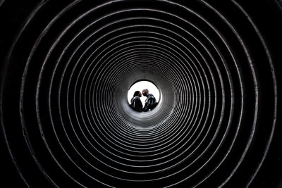 Couple kissing in the centre of a tunnel