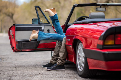 Couple Kissing in a Red Alfa Romeo