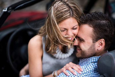 Couple Hugging on front seat of Alfo Romeo