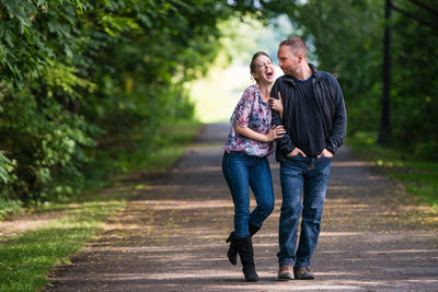 Couple Laughing While Walking In A Park