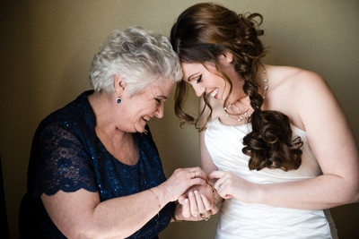 Bride and Mom Putting On Bracelet