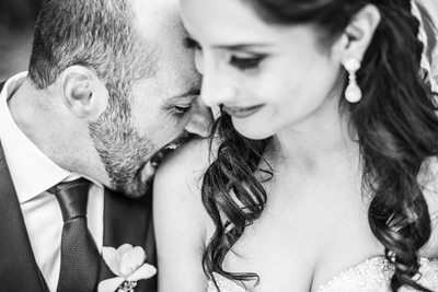 Groom Playfully Biting Bride's Shoulder