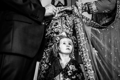 Flower Girl Looking at Bride and Groom's Ring Exchange 