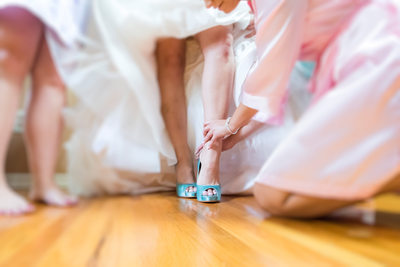 Bridesmaid Helping With Wedding Shoes