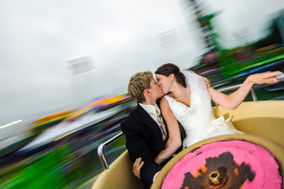 Bride and Groom Kiss at Orno Fair in Teacup Ride