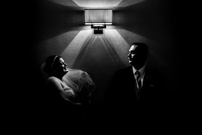 Bride and Groom Next to Light Fixture in Hotel