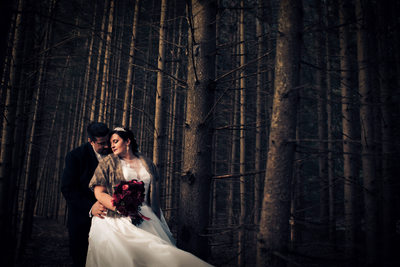 Bride and Groom in the Forest During Winter Wedding