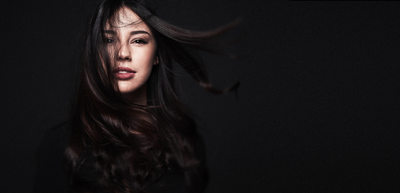 creative female headshot with hair flowing