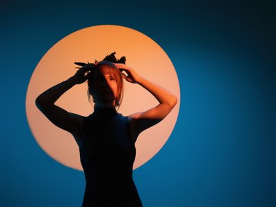 stylized portrait of girl with sun in the background
