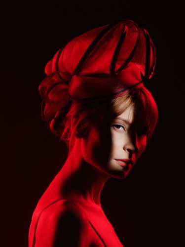 stylized portrait of model with red dramatic lighting