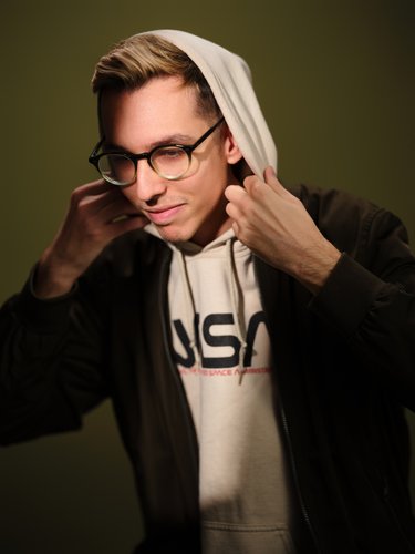 man putting on hoodie
