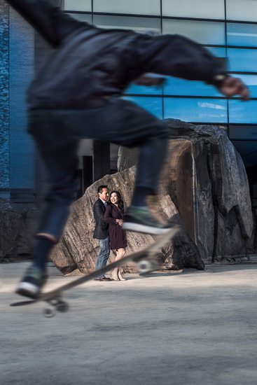 Couple with Skateboarder Jumping to Frame Them.