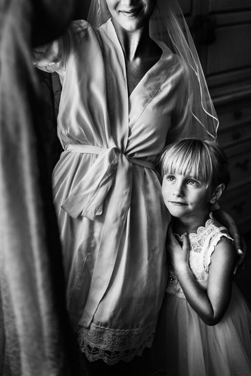 Flowergirl and Bride Looking at the Wedding Dress