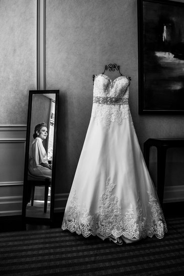 Bride in the Mirror Looking at Wedding Dress