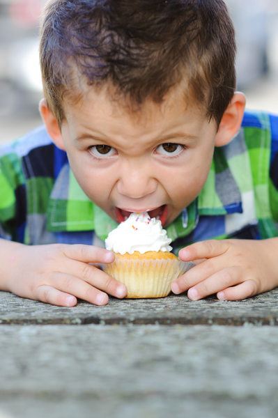 boy eating cupcake on his birthday