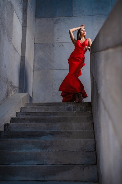 women in red dress in industrial building