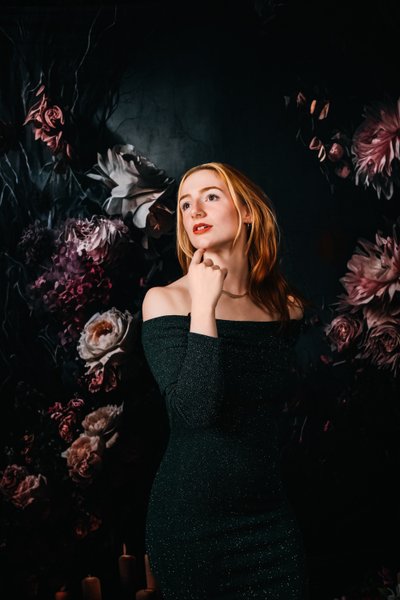 stylized dark and moody portrait of woman with flowers 