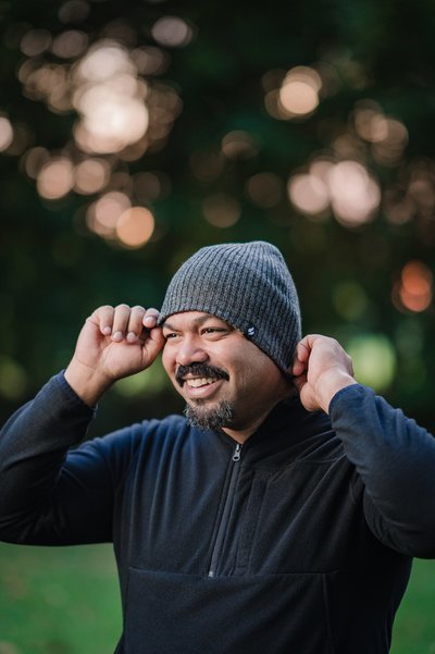 Lifestyle man putting on winter hat