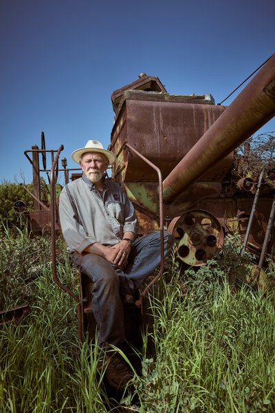 Farmer with old farm equipment