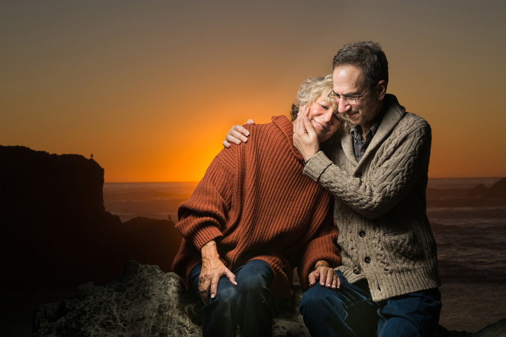 older couple posing together sunset