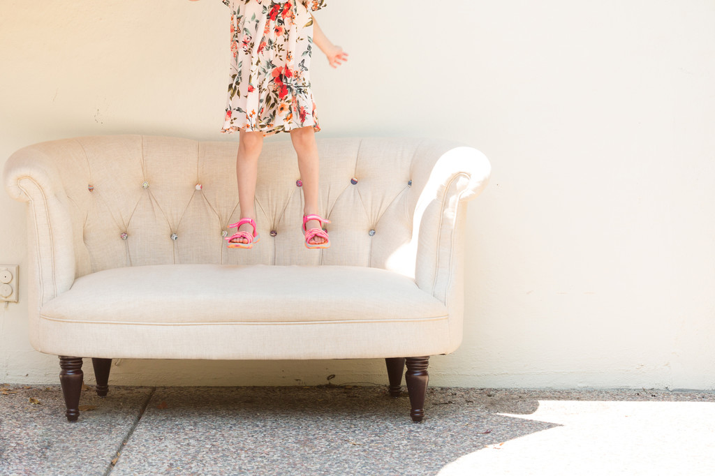young-girl-jumping-on-couch