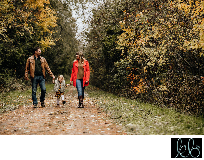 Family of three walking at Mill Lake Park