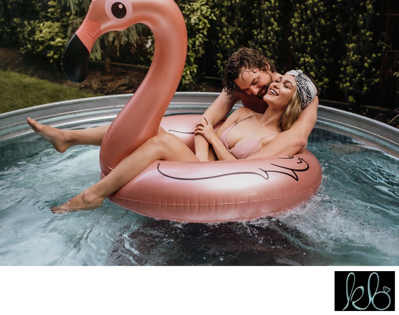 Couple laughs in the Pool with Flamingo