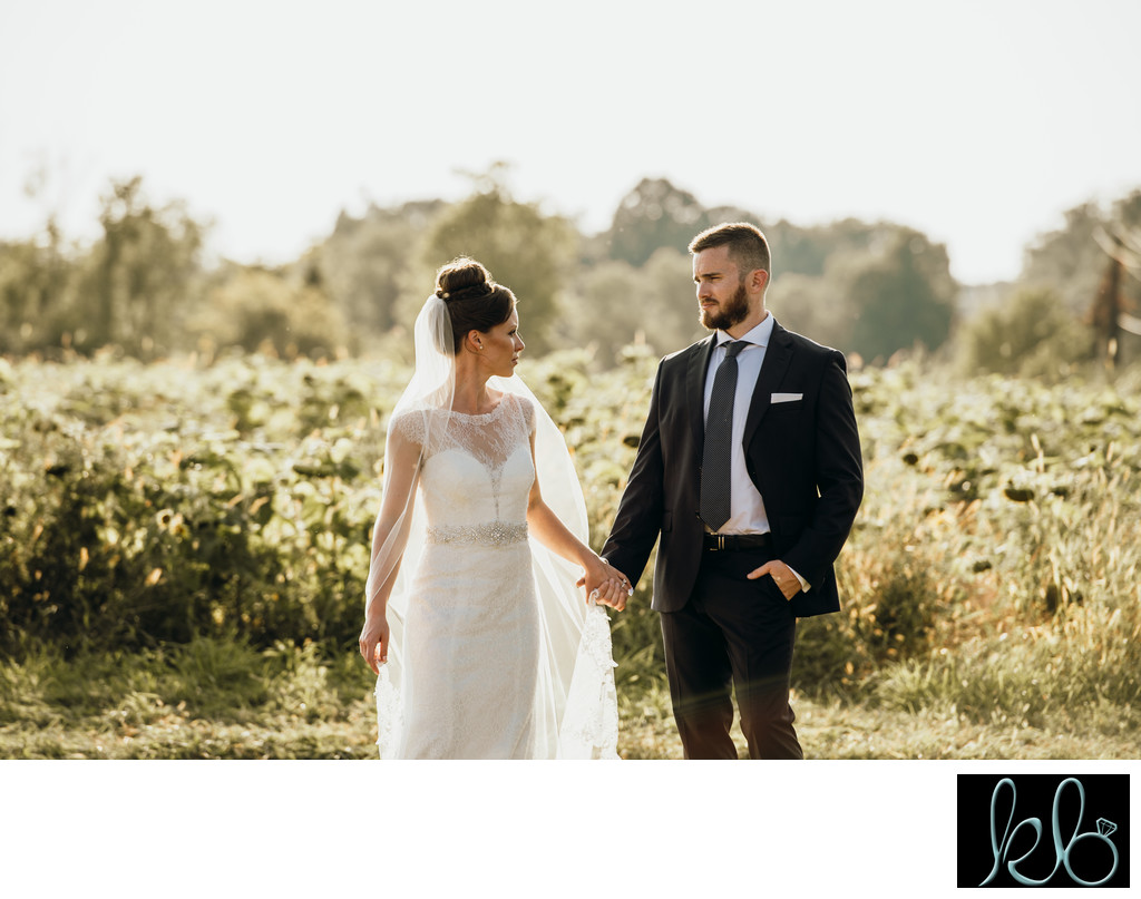 Photo of Bride and Groom in Sunflower FIeld
