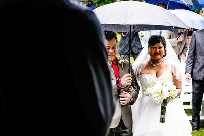 Rainy Ceremony Photo of Father Giving Away the Bride