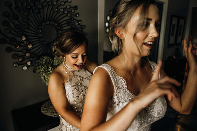 Bride and Bridesmaid Getting Ready For Ceremony