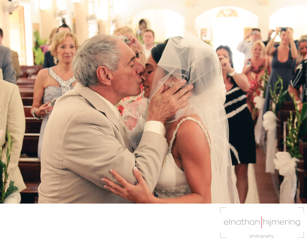 bride in church kissing father aruba