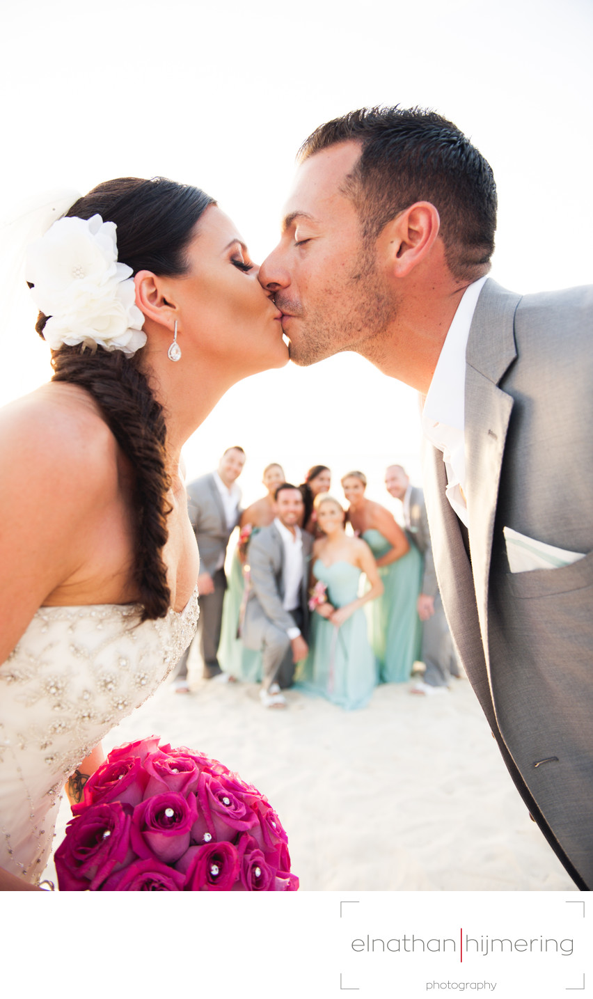 bride groom kissing beach weddingparty