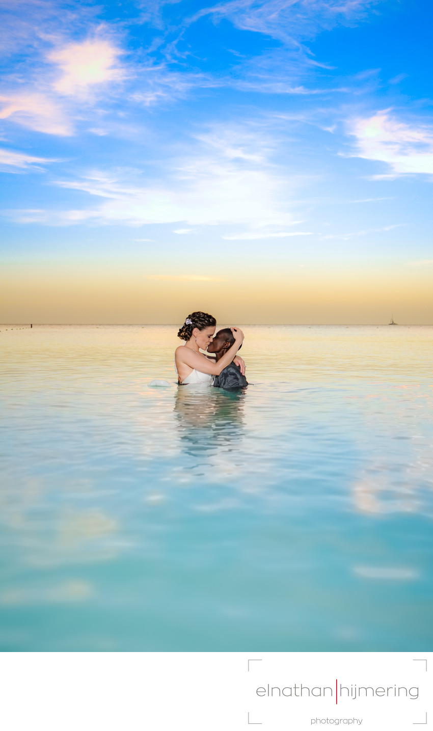 Same sex couple in water sunset