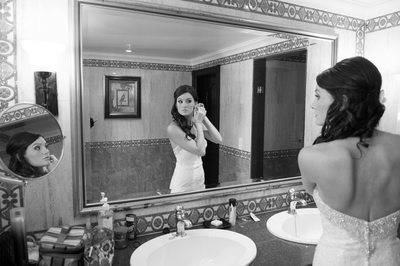bride in mirror getting ready
