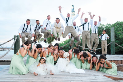 groomsmen jumping on brides