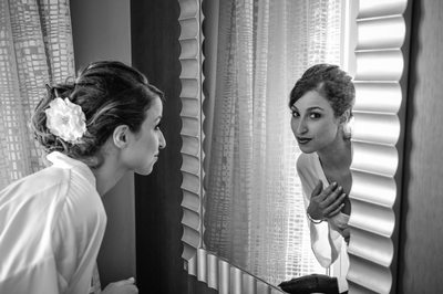 bride peeking in mirror