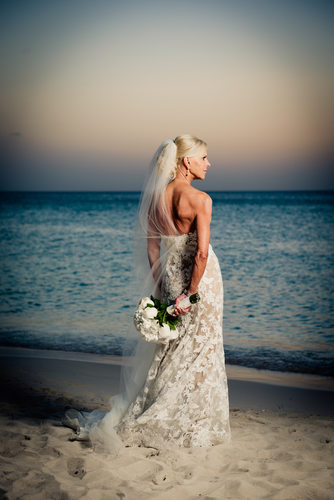 bride holding flowers behind back