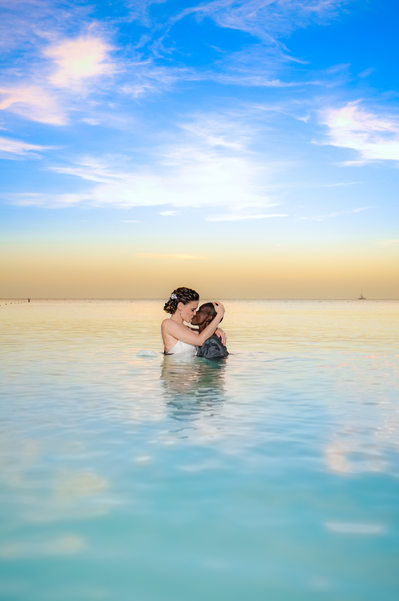 Same sex couple in water sunset