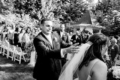 Groom reacts to veil falling in the wedding procession