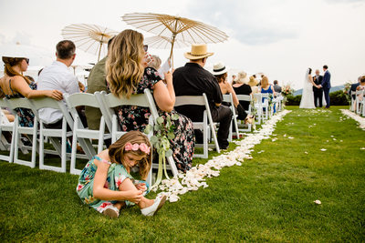 Young wedding guest entertains herself during ceremony