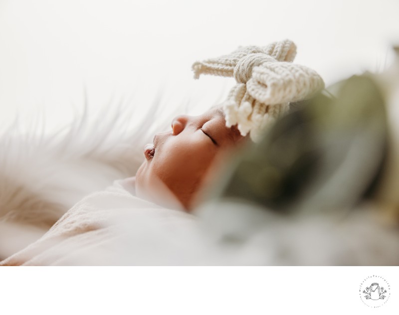 Newborn Sleeping Peacefully with Greenery Foreground