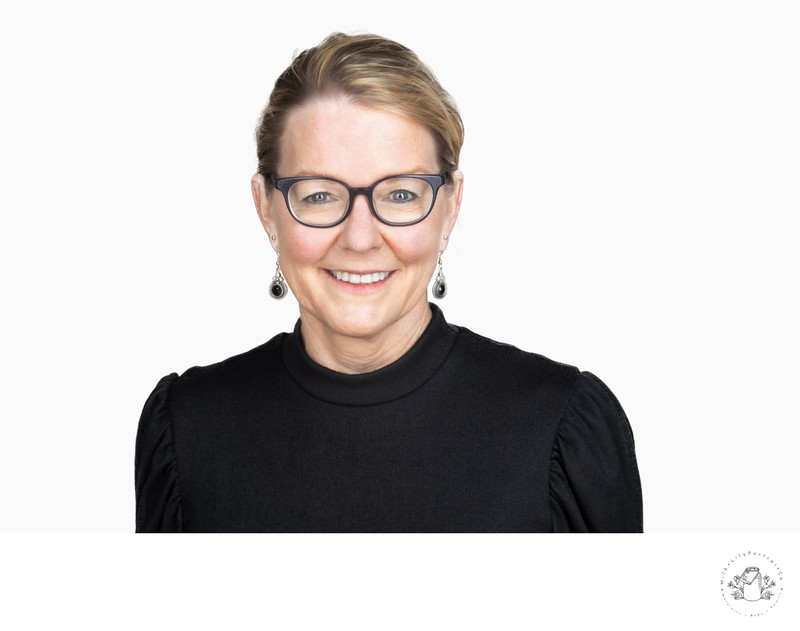 Corporate female executive headshot with glasses