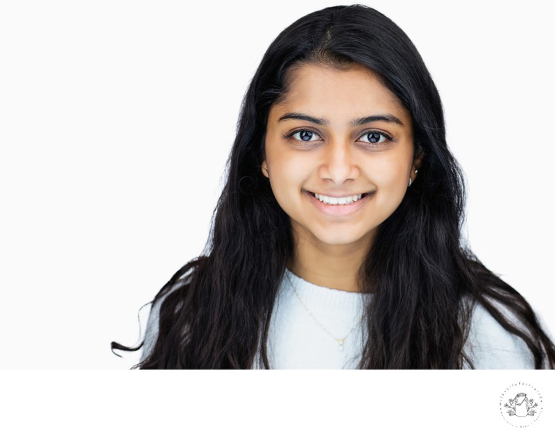 corporate headshot of an indian woman smiling